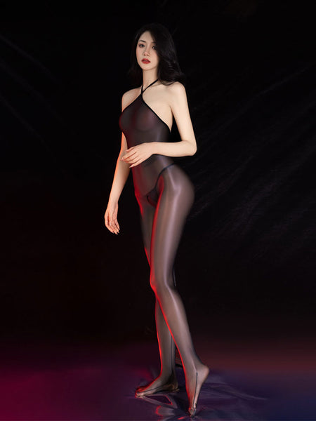 Front view of lady wearing a black sheer shiny bodystocking featuring a halter neck, closed feet and an open crotch.