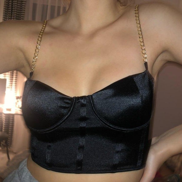 Black sexy corset crop top featuring a adjustable shoulder straps, back zipper closure and a low cut back. 