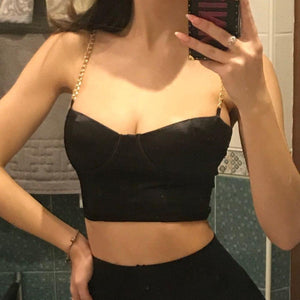 Black sexy corset crop top featuring a adjustable shoulder straps, back zipper closure and a low cut back. 